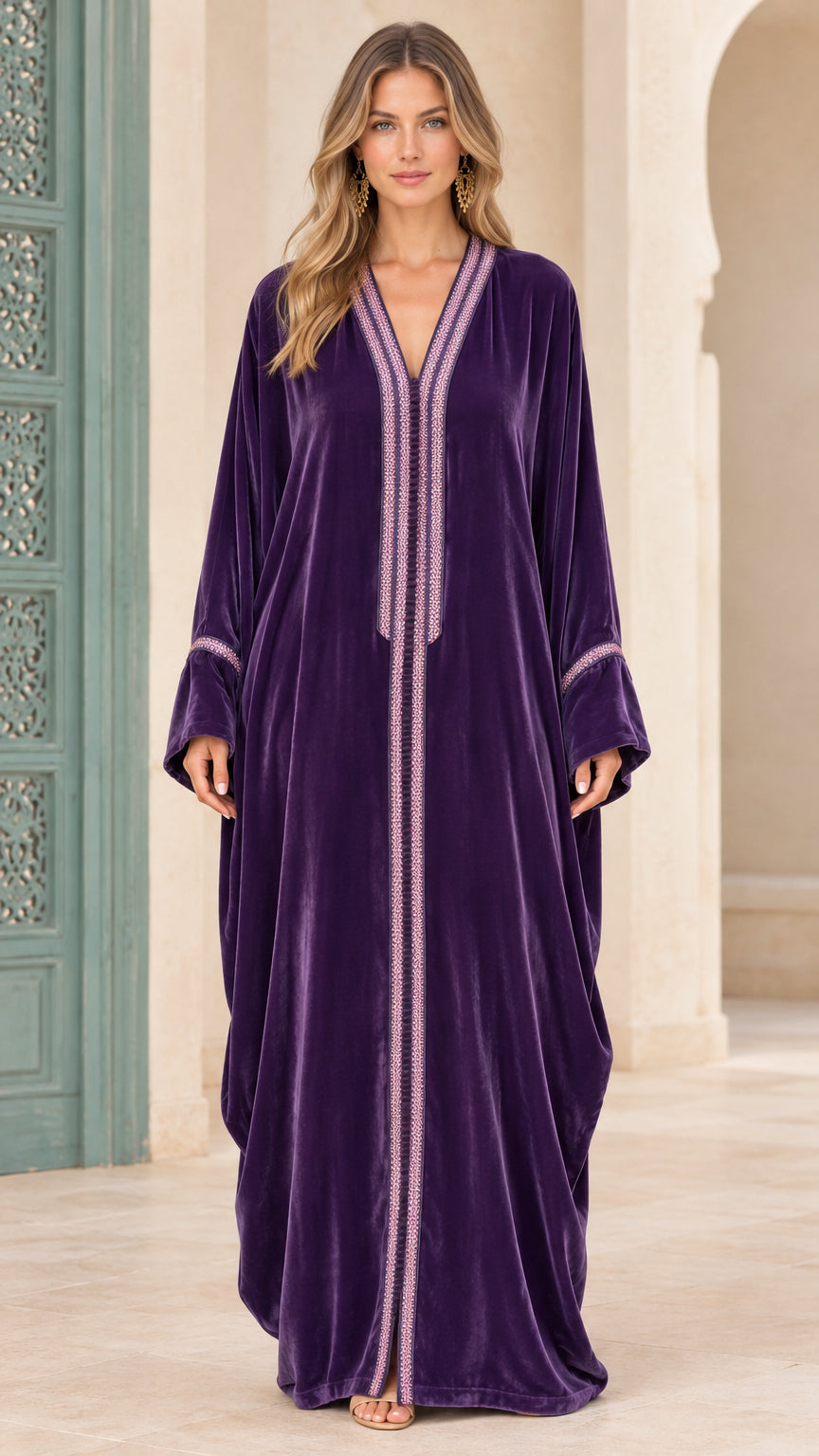 Front view of woman wearing deep purple embroidered velvet kaftan maxi dress