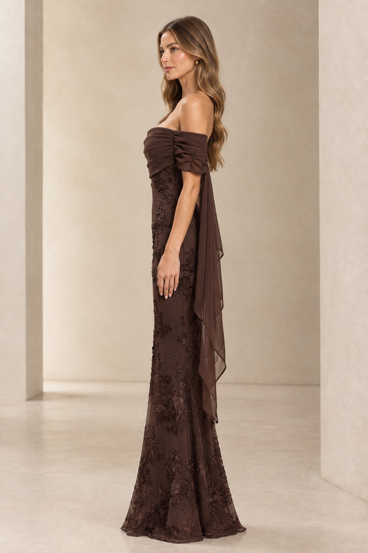 Side profile view of chocolate brown lace embroidered gown showing draped side chiffon cape detail
