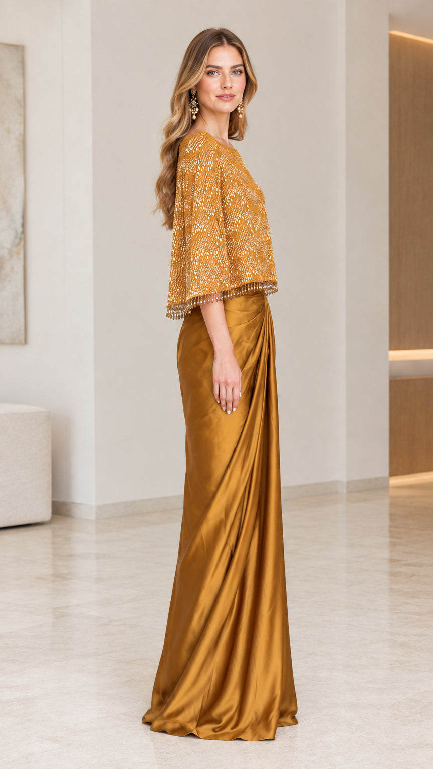 Side profile view of the Gold beaded capelet maxi dress