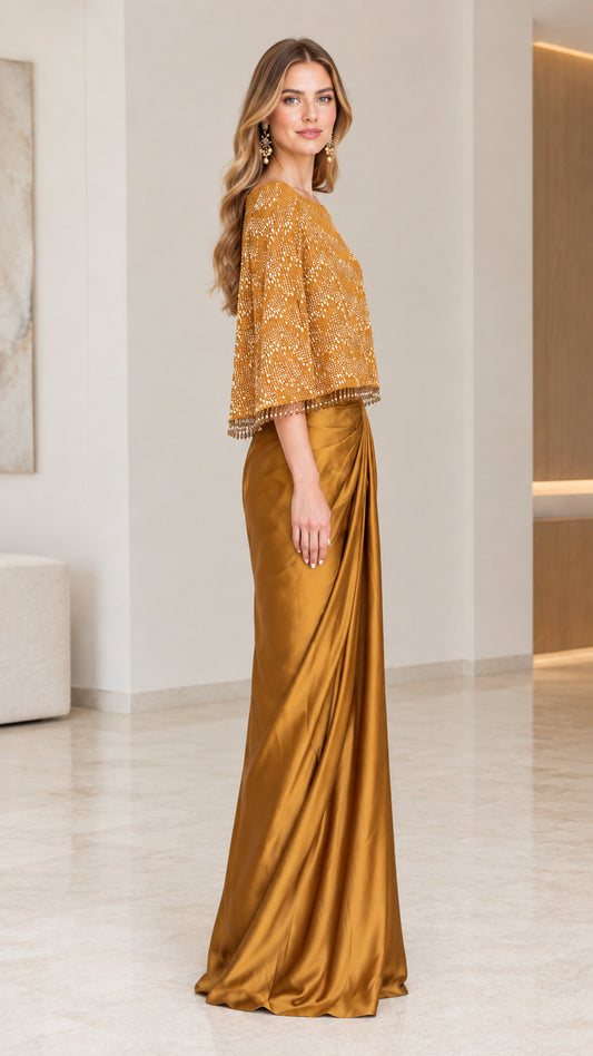 Side profile view of the Gold beaded capelet maxi dress