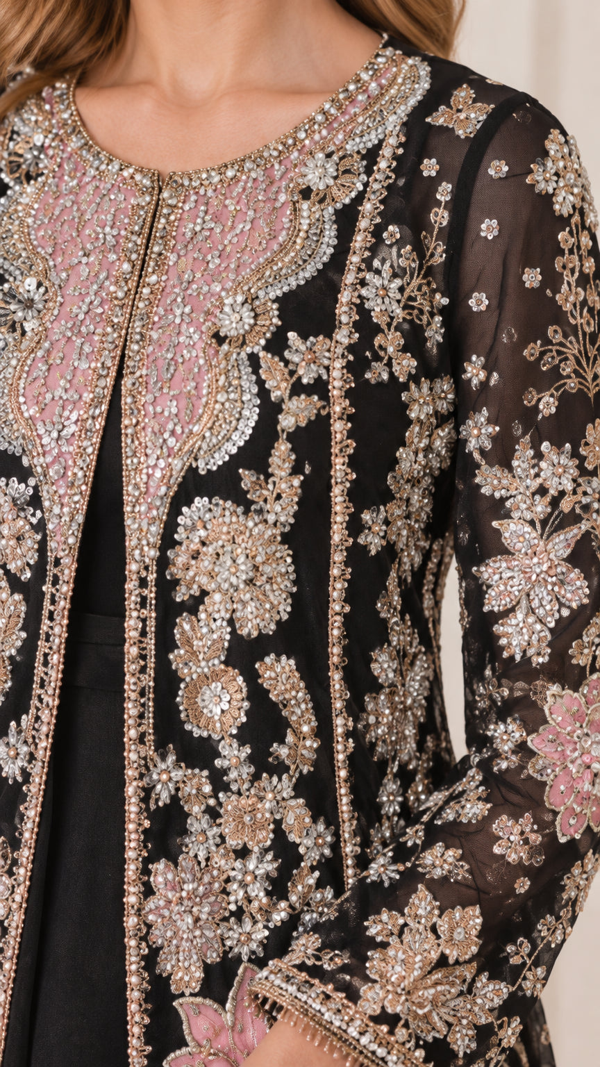 Close-up detail of pink and gold floral beadwork, sequins, and neckline on jacket