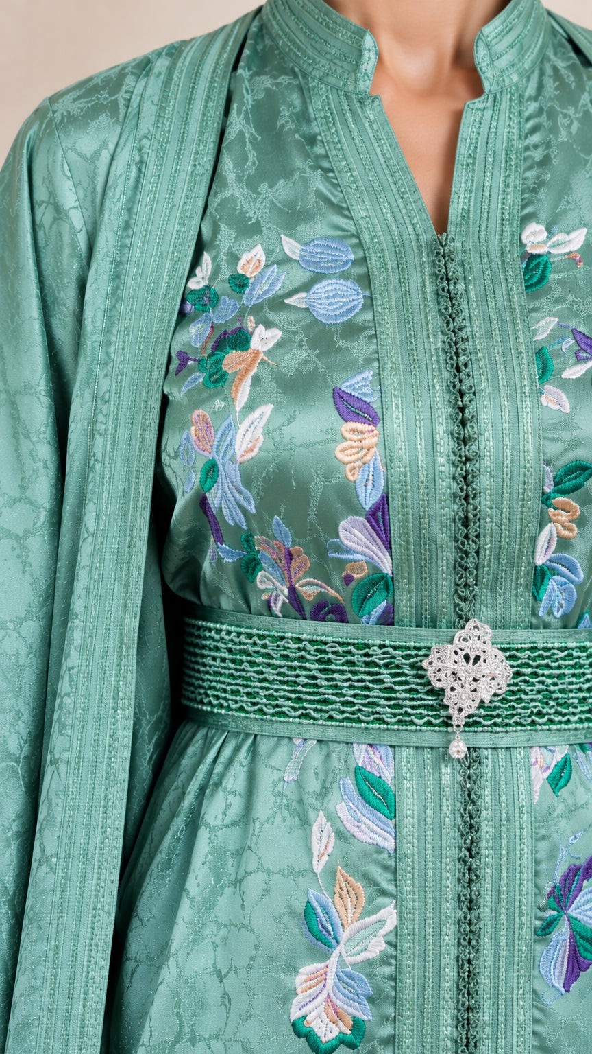 Close-up detail of Sage Green embroidered neckline and bejeweled waist belt