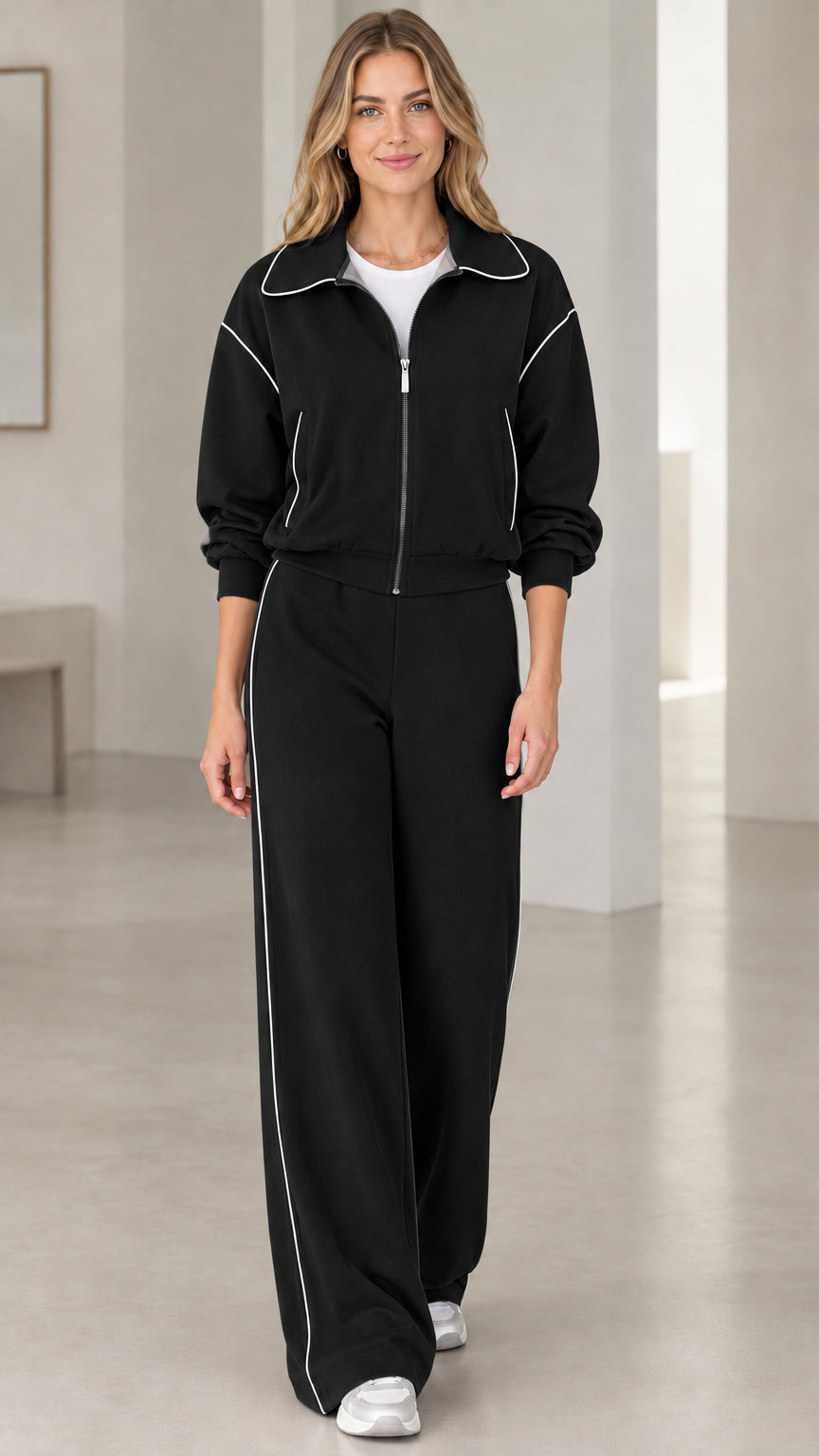 Front view of model wearing Black two-piece tracksuit set with white contrast piping