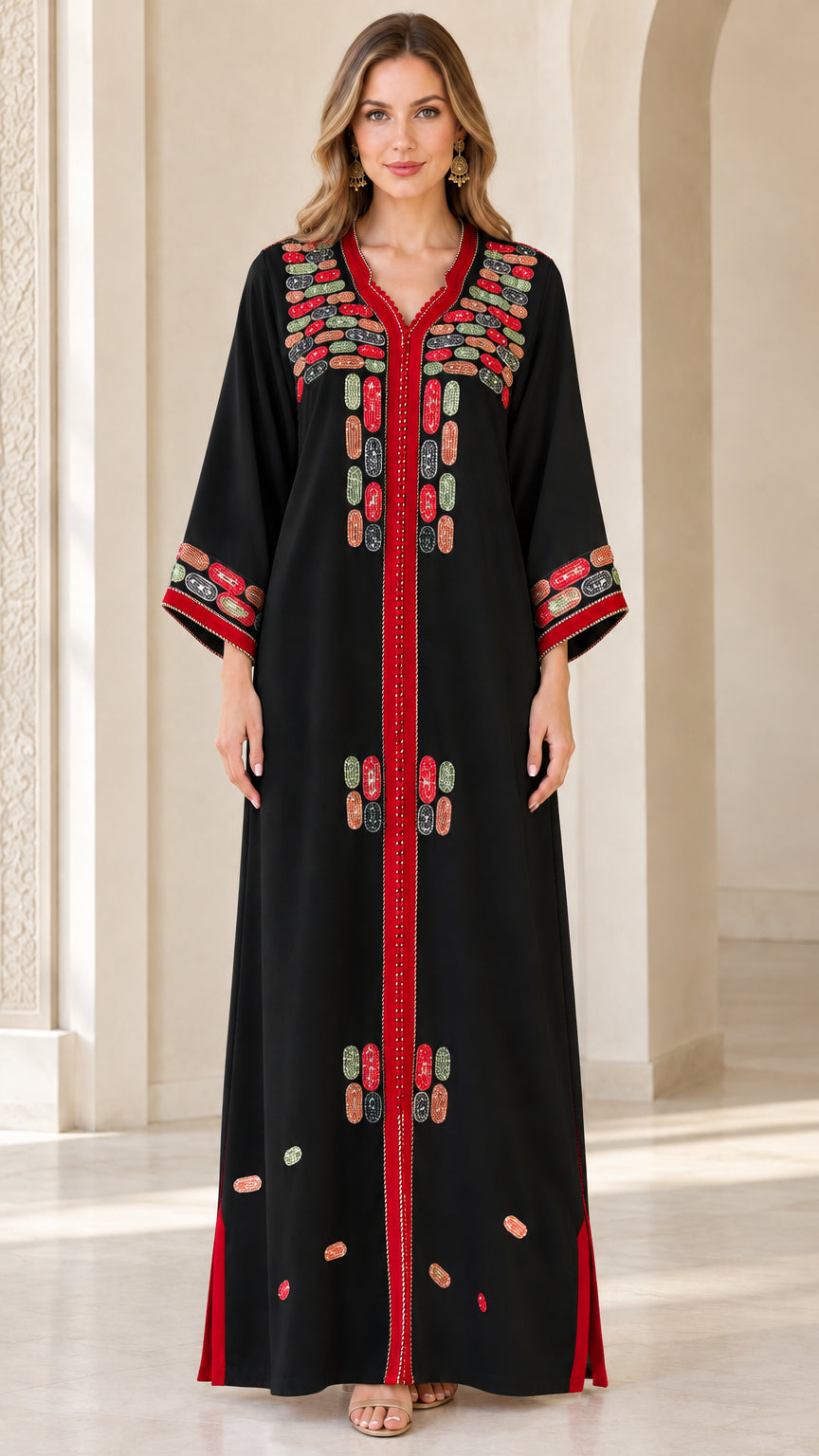 Front view of model wearing black embroidered maxi kaftan dress with red accents