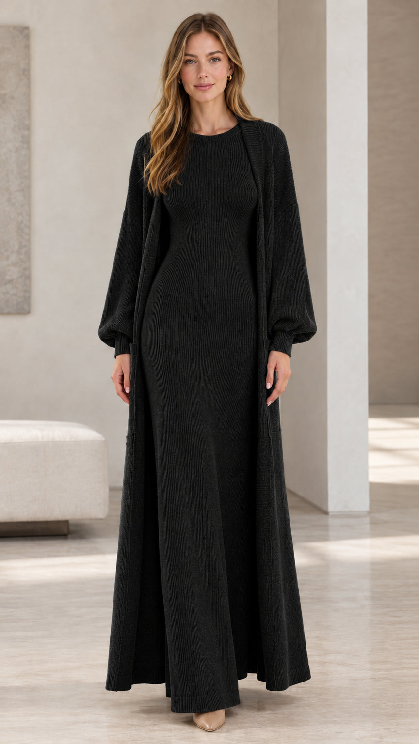 Front view of woman wearing black ribbed knit maxi dress and matching long duster set