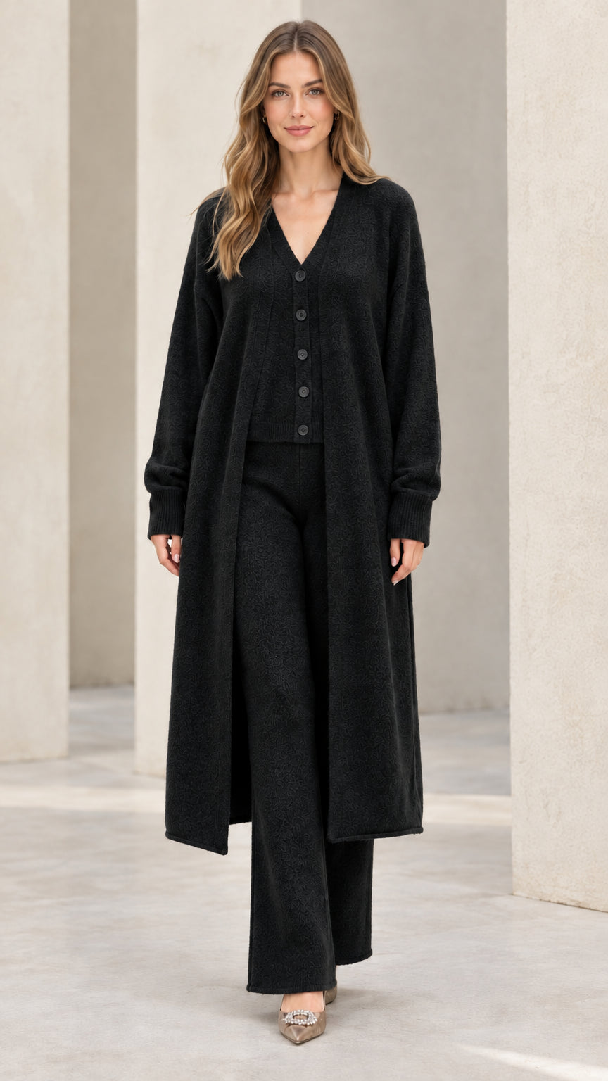 Front full-length view of model wearing black 3-piece knit duster and pants set
