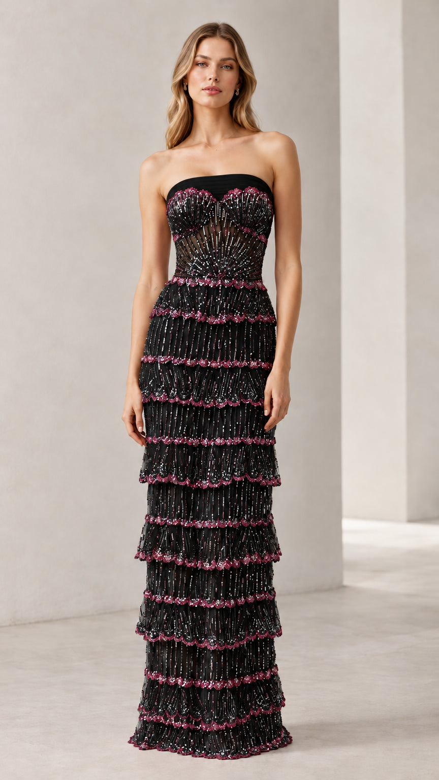 Full-length view of woman wearing black strapless beaded tiered evening gown