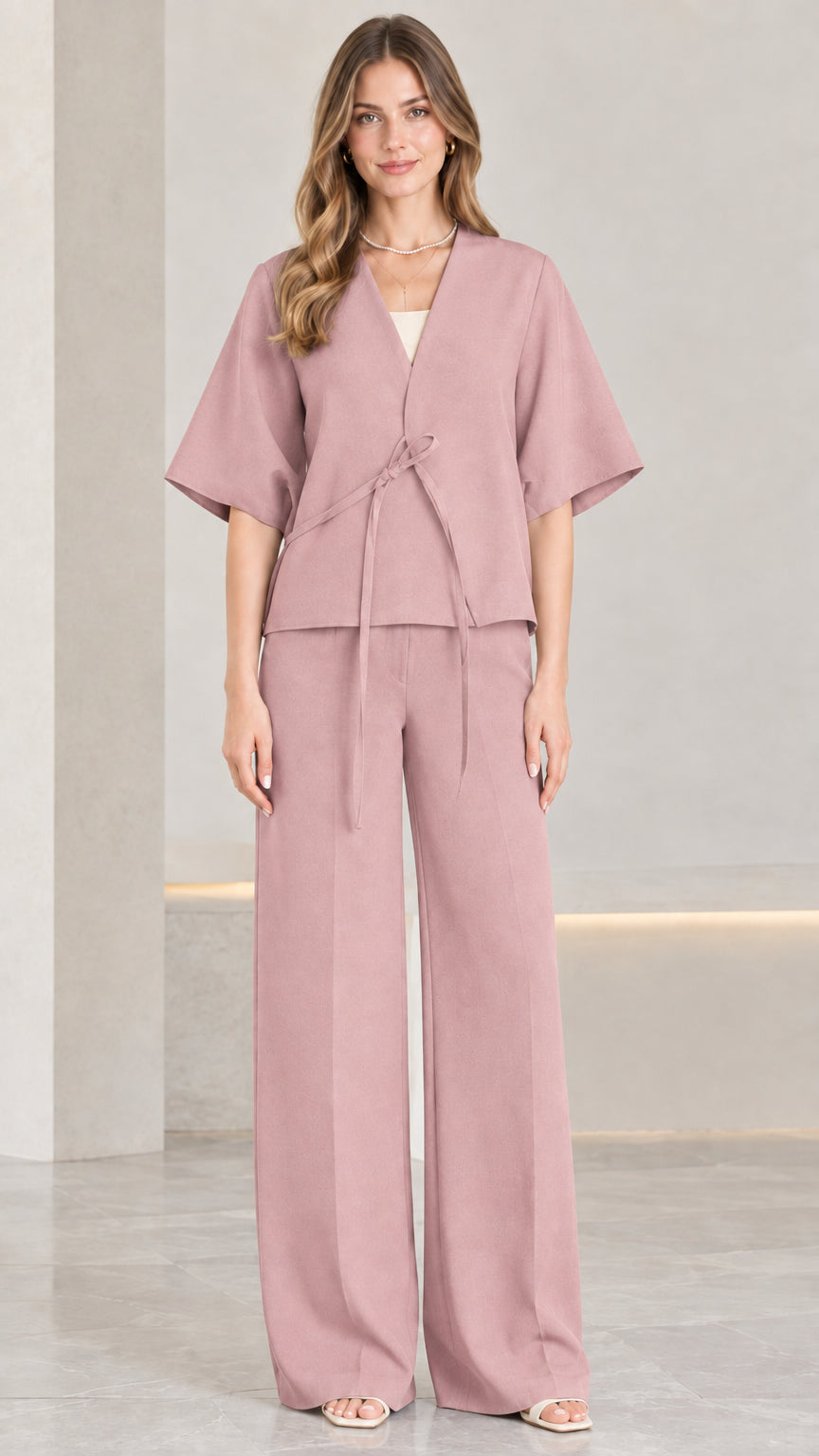 Front view of woman wearing dusty rose tie-front top and matching wide-leg trousers
