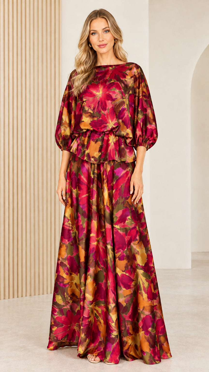 Front full view of woman wearing deep burgundy and gold floral satin maxi dress