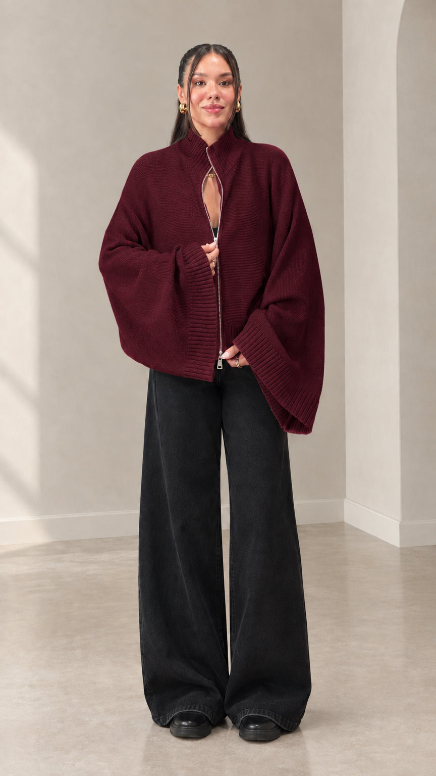 Woman wearing burgundy zip-front mock neck knit sweater