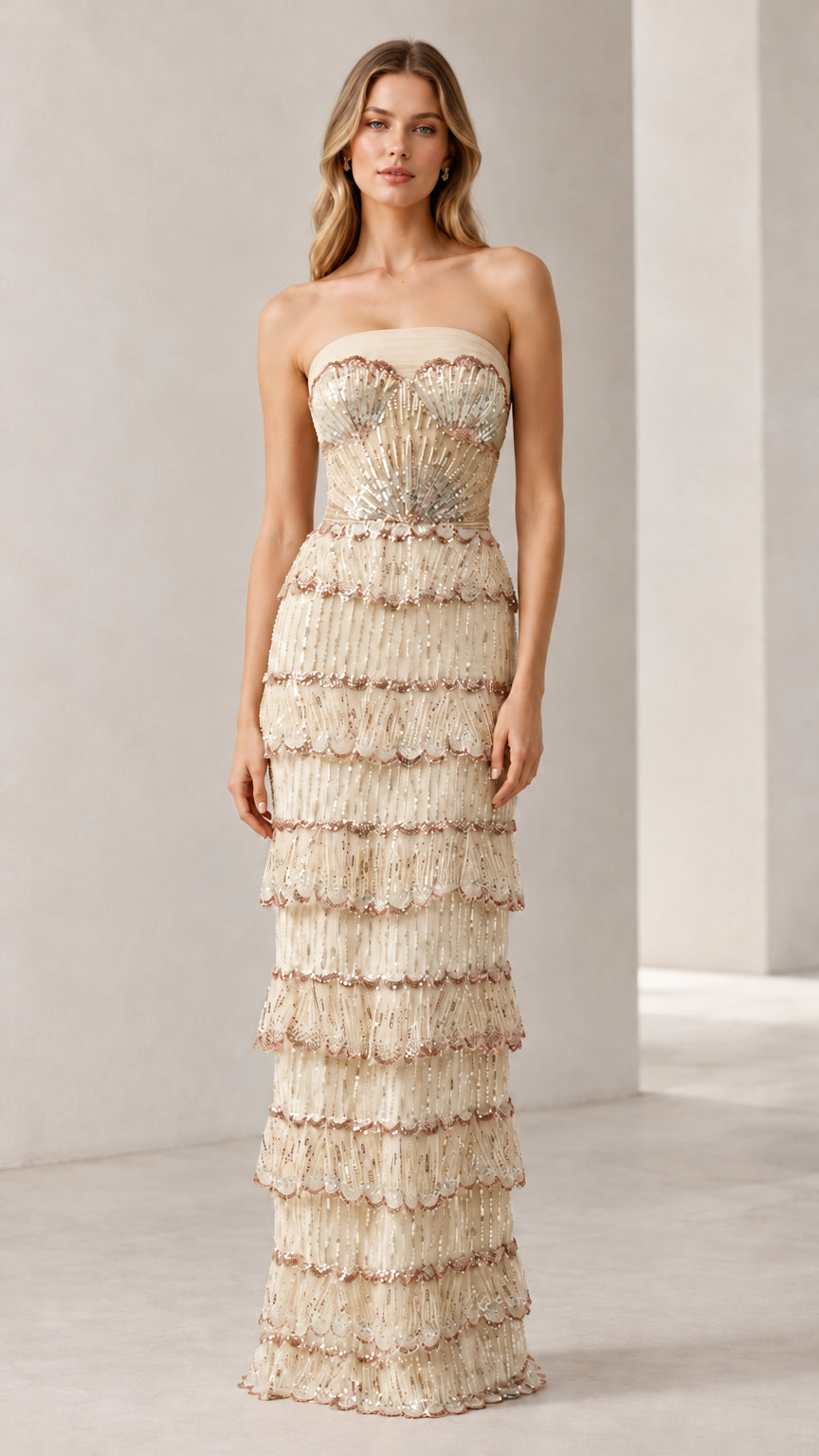 Full-length view of woman wearing champagne strapless beaded tiered evening gown