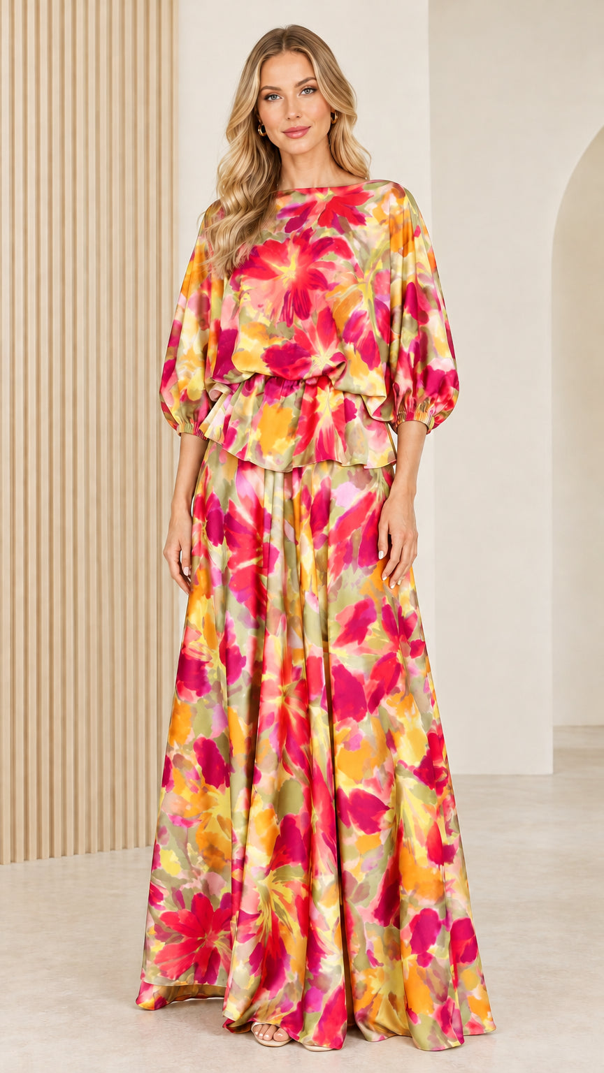 Front full view of woman wearing vibrant yellow and pink watercolor floral maxi dress