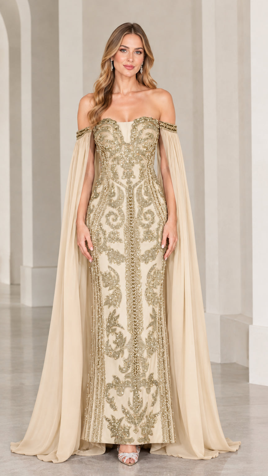 Champagne and gold embellished floor-length gown with dramatic cape sleeves