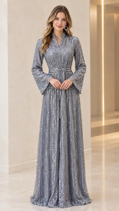 Front view of model wearing full-length silver sequin maxi dress with long bell sleeves and waist belt