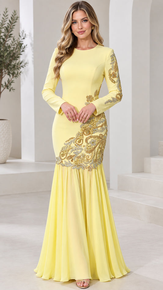 Front view of model wearing pastel yellow long sleeve mermaid gown with gold embroidery