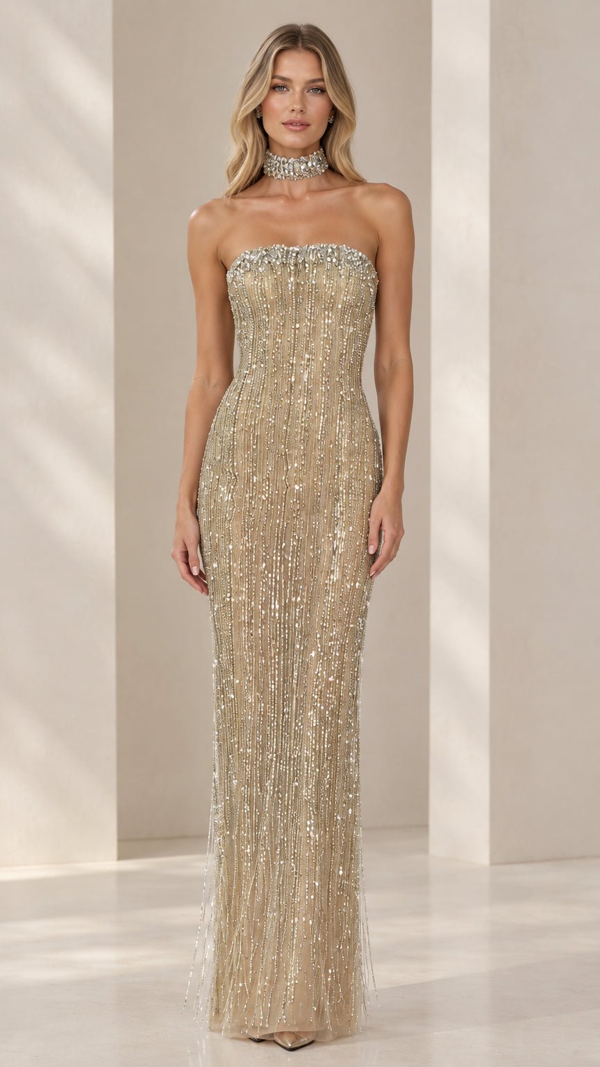 Front view of model wearing Champagne Gold strapless beaded column evening gown with crystal neckline