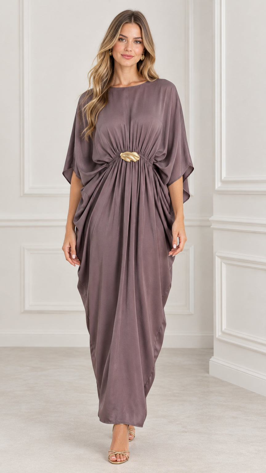 Front view of model wearing a mauve draped kaftan maxi dress with gold buckle accent