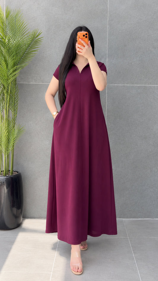 Front view of woman wearing Burgundy short sleeve polo collar maxi dress with hand in pocket