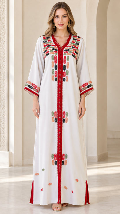 Front full-length view of model wearing white embroidered maxi kaftan dress with red trim