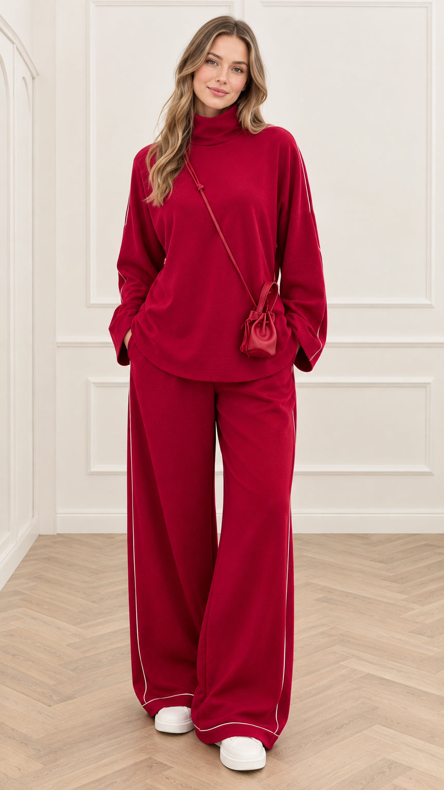 Front view of woman wearing red mock neck top and wide leg pants set with white piping