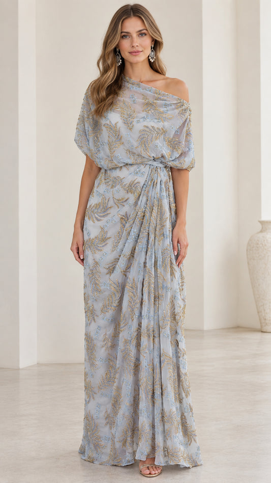 Front view of woman wearing slate blue one-shoulder embroidered draped maxi dress