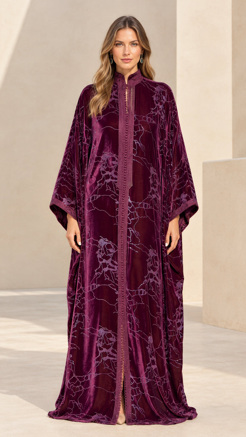 Front full-length view of model wearing plum embroidered velvet maxi kaftan dress