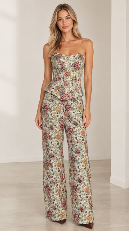 Full front view of model wearing cream floral tapestry strapless peplum top and wide-leg pants set