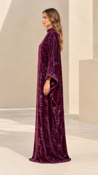 Side profile view of plum velvet embroidered maxi kaftan gown