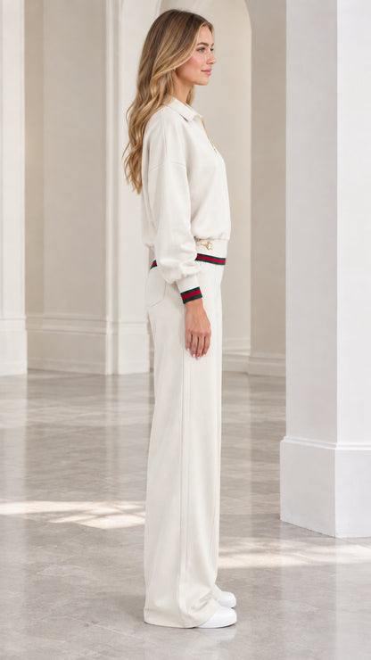 Side profile view of women's cream two-piece tracksuit set