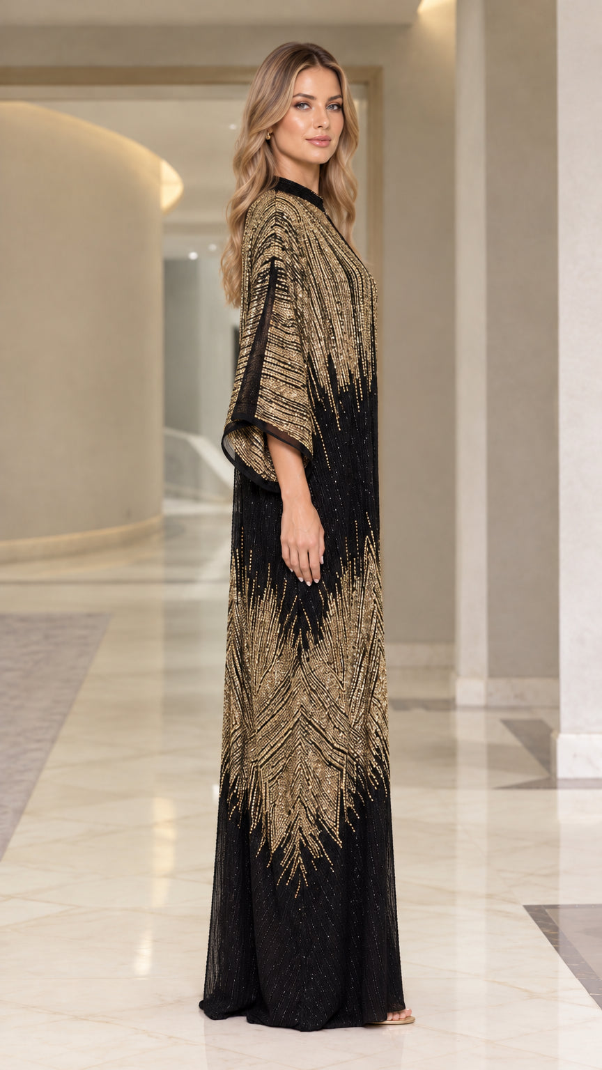 Side profile view of woman modeling black and gold sequin evening kaftan