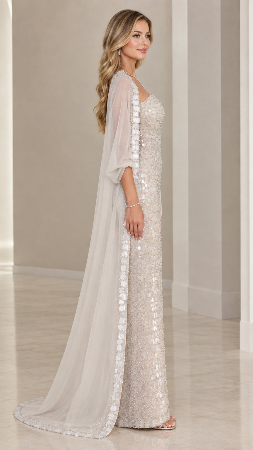 Side profile of champagne embellished evening gown with flowing chiffon cape