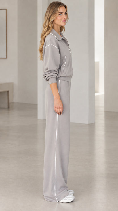 Side profile view of model wearing Heather Grey loungewear set with white side piping