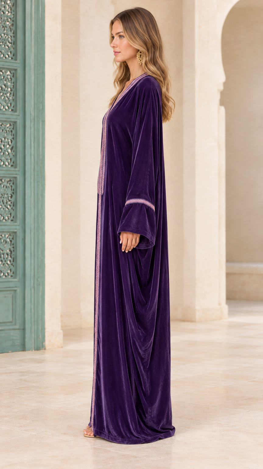 Side profile view of deep purple long velvet kaftan gown