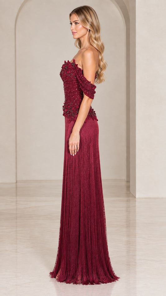 Side profile of burgundy off-the-shoulder beaded bodice maxi gown with fringe skirt