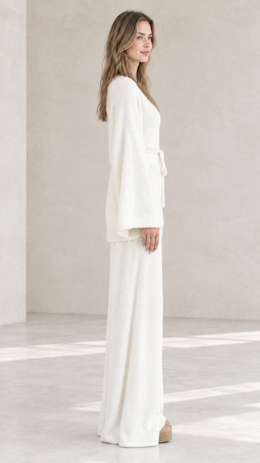 Off-white fuzzy knit loungewear set side view showing belted longline cardigan