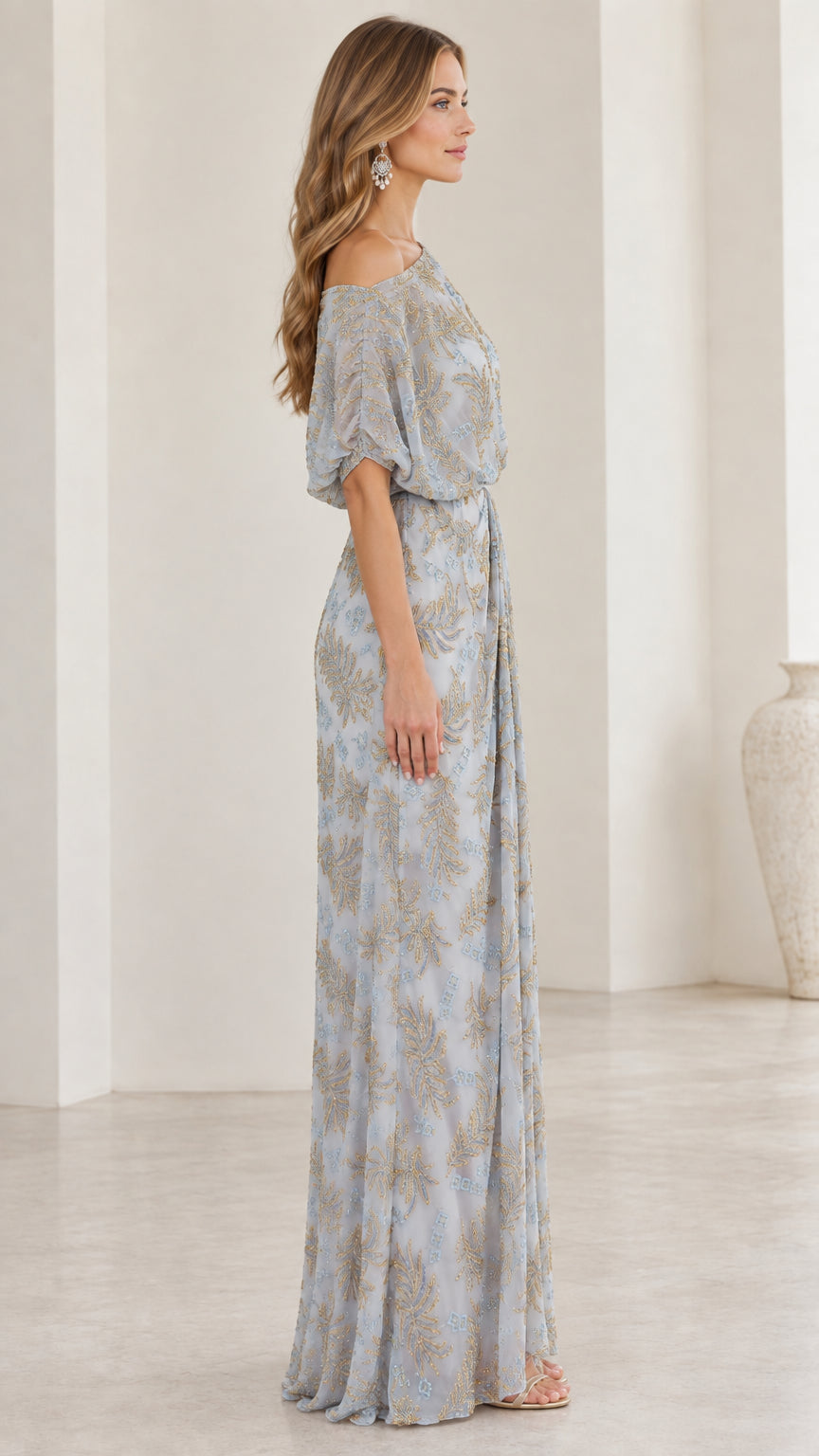 Side view of woman wearing slate blue one-shoulder embroidered evening gown