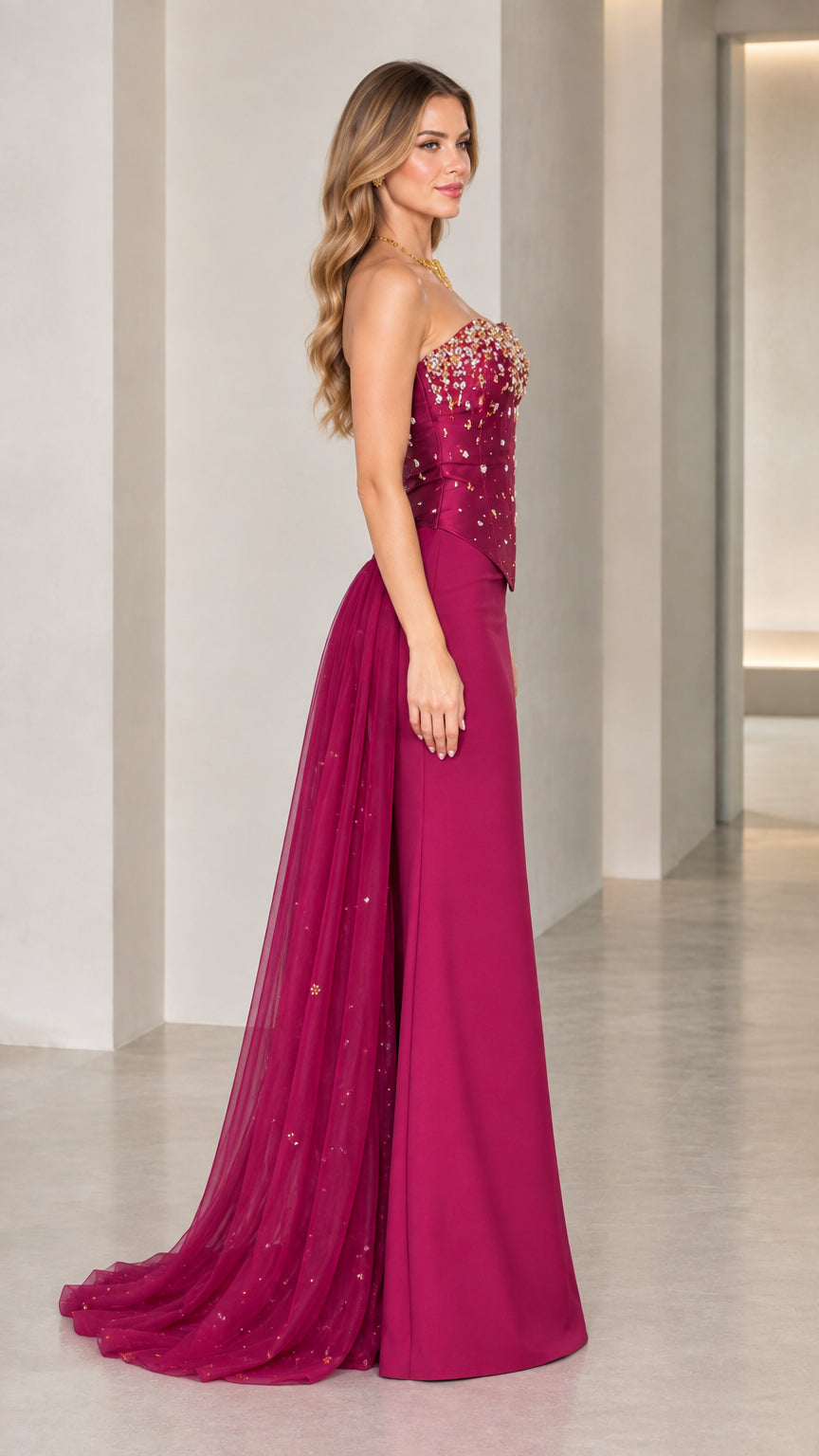 Side profile of model in magenta strapless formal gown showing floor-length train