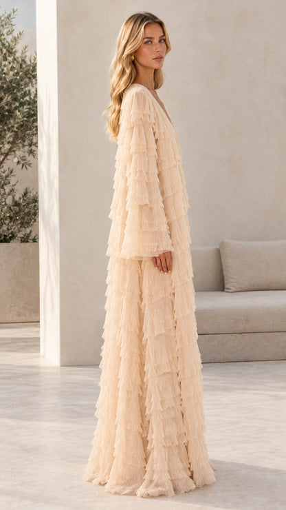 Model wearing champagne textured ruffle maxi dress side angle view