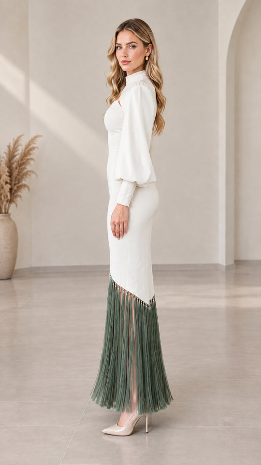 Side view of model wearing white long sleeve cutout evening dress with fringe trim