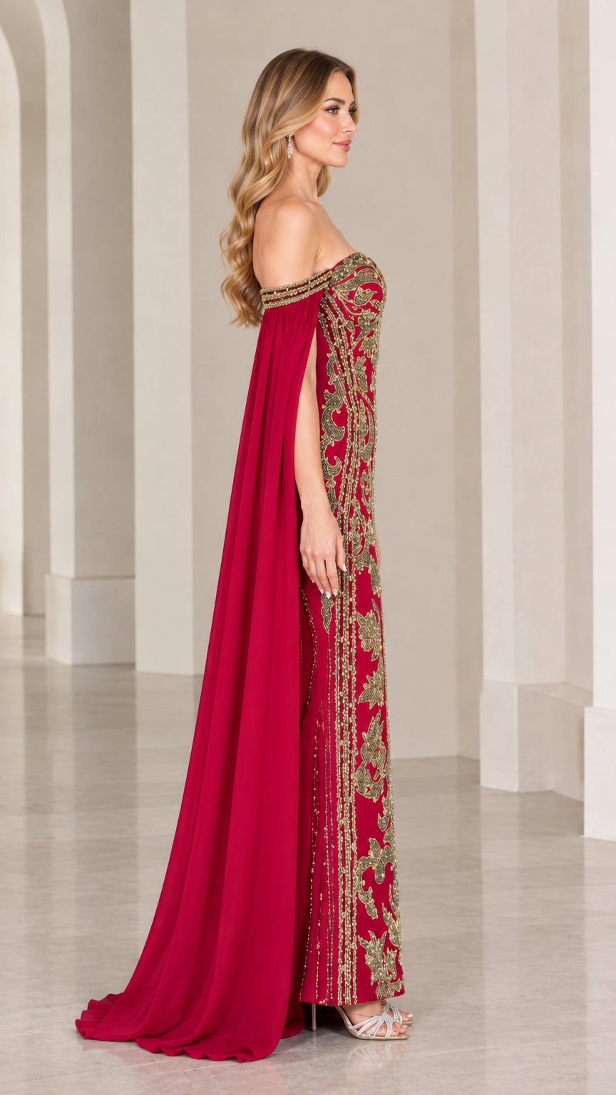 Side profile of burgundy formal gown showing floor-length cape sleeve drape
