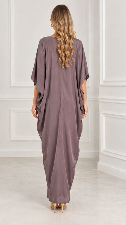 Back view of model wearing mauve flowing kaftan maxi dress