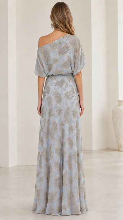 Back view of woman wearing slate blue one-shoulder maxi dress