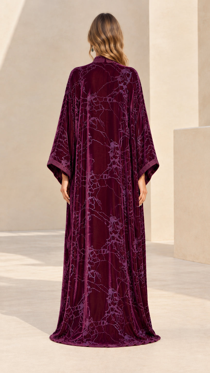 Back full-length view of flowing plum velvet kaftan with floral embroidery