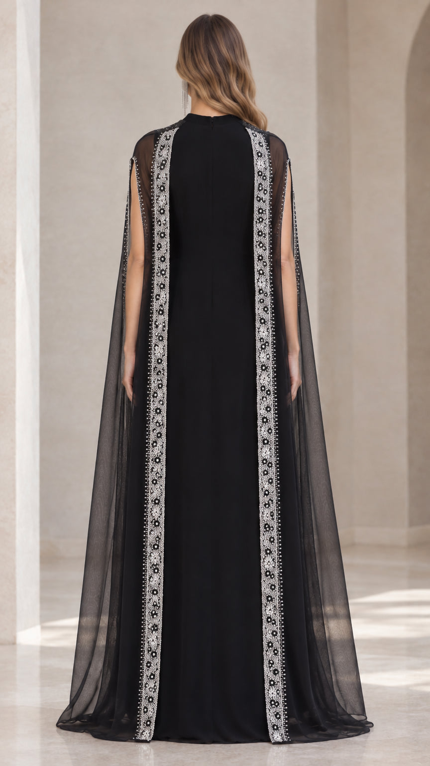 Back view of black formal evening gown with sweeping sheer cape
