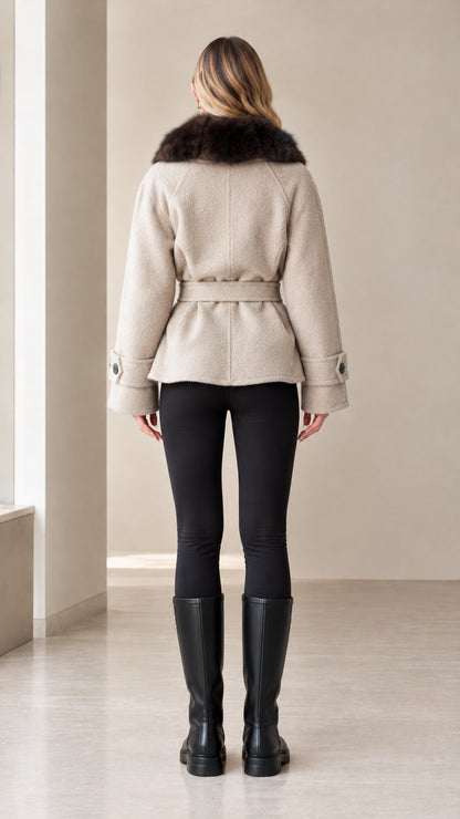 Back view of woman wearing beige belted short coat showing fit and hemline