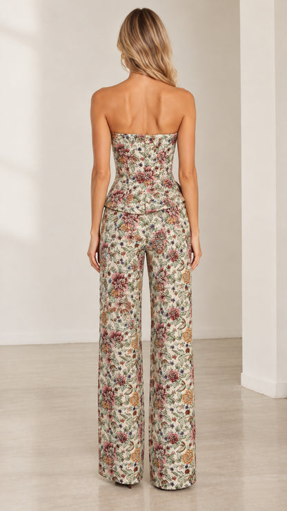 Back view of model in cream floral tapestry two-piece peplum pants set