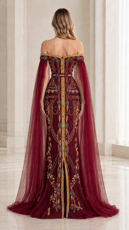 Back view of woman wearing burgundy formal evening gown with long tulle cape