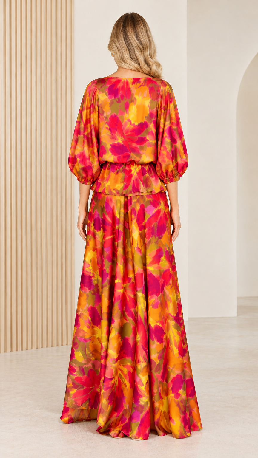 Back view of woman wearing elegant orange and fuchsia watercolor floral maxi dress