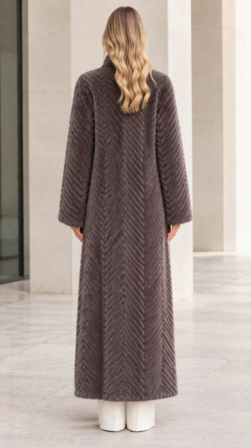 Back view of full-length charcoal grey chevron faux fur coat