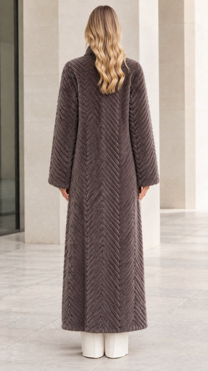 Back view of full-length charcoal grey chevron faux fur coat